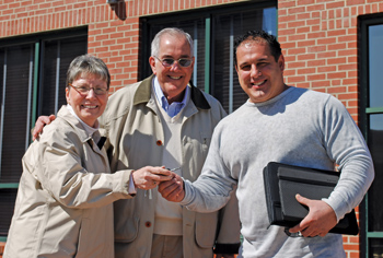 jim torres and his wife, vivian (left) pass the keys to new owner joe cunha (right).