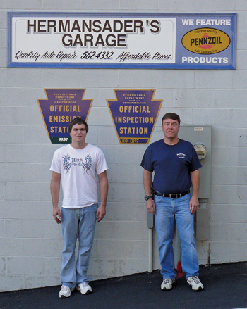 the buyers: new owners of hermansader's garage, chris yost (left) and his father-in-law jeff pettit, pose in front of their newly acquired business.