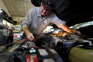 Ken Volland works on a car at his service station along University Way in Ellensburg, Thursday, Sept. 16, 2010. The station, owned by Volland since the mid-1980s, will close its doors at the end of the month. (Brian Myrick / Daily Record)